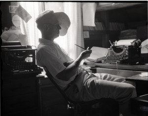George Allan England seated as his Monarch typewriter