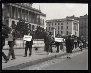 Protesters supporting Sacco and Vanzetti, carrying signs reading "If they are not innocent, why are you afraid of a new trial?"