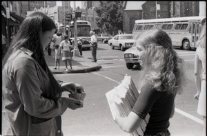 Crew distributing Free Spirit Press magazine: woman purchasing a copy