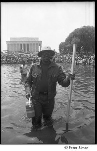 Unidentified protestor wading in a Mall reflecting pool during the Poor People's Campaign Solidarity Day