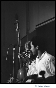 Govinde, with finger cymbals, performing with Amazing Grace at the Energy Center (Bhagavan Das in background, obscured)