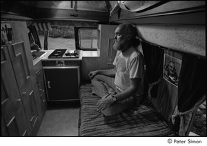 Ram Dass in his van: Ram Dass meditating next to a picture of Neem Karoli Baba