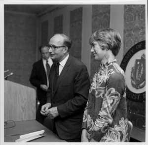 Robert C. Wood standing near podium with a woman