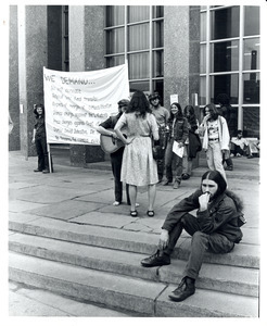 Board of Trustees fee increase demonstration: protestors on the steps of the Student Union, Charles Bagli with sign (far left)