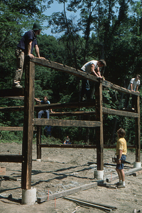 Peter Jensen adjusting top eastern beam at the Moon Barn Raising at entrance to Hopkins Forest on 2 August 1975.