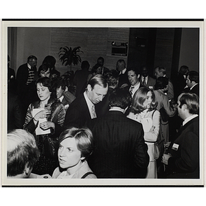 People stand and talk in small groups at a Boys' Clubs of Boston event ...