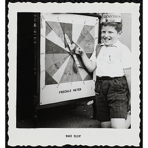 Johnny DiReeno, 9, Boys' Club Freckle King Contest winner, points to his score on the freckle meter
