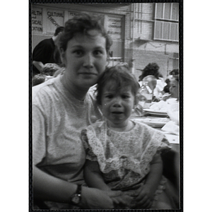 A woman posing with a girl on her lap at a Kiwanis Awards Night