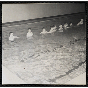 Boys wade in a natorium pool