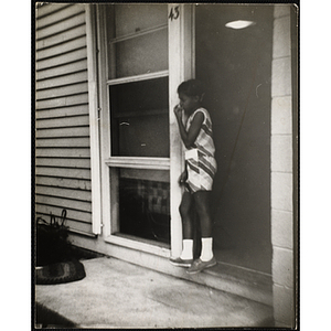 A girl stands in a doorway