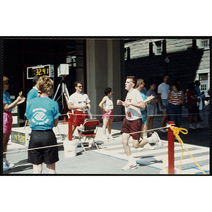 A man finishes running the Battle of Bunker Hill Road Race