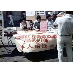 Suzanne Lee and others at the Chinese Progressive Association's table at the August Moon Festival