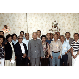 Men and women pose in a group at a dinner party in Nanjing, China