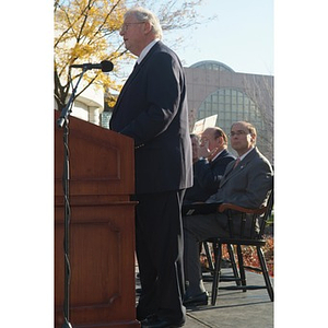 Neal Finnegan speaks from the podium at the Veterans Memorial dedication ceremony