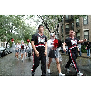 The NU cheerleaders march in the Homecoming parade