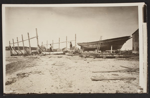 Two men working with tools in a shipyard, Vineyard Haven, Martha's Vineyard, Mass., undated
