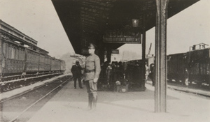 View of a soldier [M. P. Louis Baker] standing on a train platform