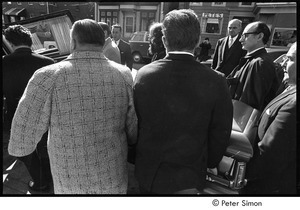 Jack Kerouac's funeral: pallbearers loading casket into the hearse, Allan Ginsberg back-center