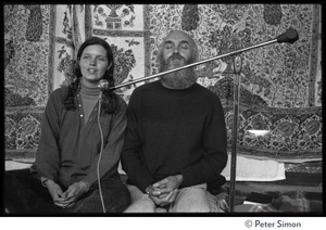 Ram Dass and woman on stage at the Rowe Center spiritual retreat