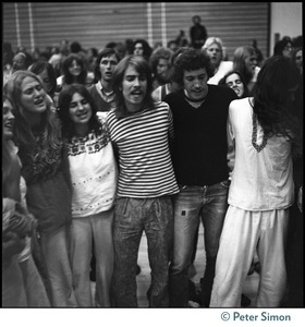 Audience linking arms and singing during the appearance of Ram Dass at Sonoma State University