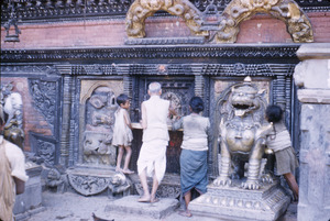 People making offerings at shrine