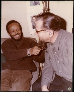 Bernie Moss (right) wearing a false beard and joking around with an unidentified man