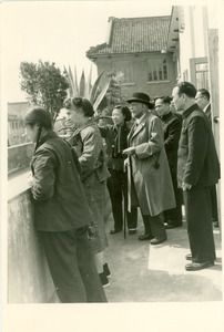 W. E. B. Du Bois, Shirley Graham Du Bois, and others, looking from veranda