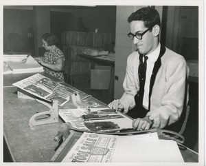 Man and woman working at a long table