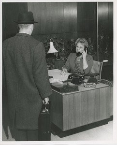 Mrs. Frances Marsala seated in her wheelchair working as a receptionist