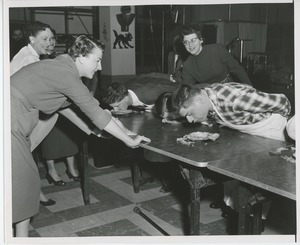 Clients competing in a pie eating contest at Halloween party