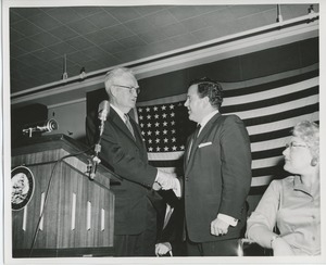 Bruce Barton shaking hands with client at graduation exercises