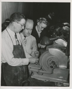 William Murphy working on optical lens grinding equipment