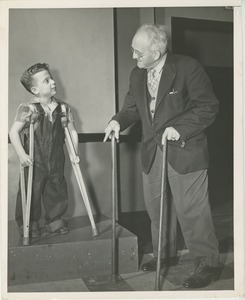 Boy with crutches and a man with canes