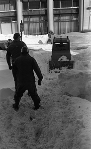 Snow clearing equipment and unidentified men clearing snow on Berkeley Street