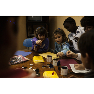 Children working at a table on art projects