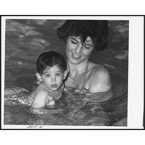 Woman and baby swimming in pool at West Roxbury branch