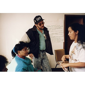 Two women and one man involved in what appears to be an intense discussion during an Inquilinos Boricuas en Acción staff meeting.