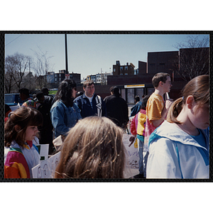 Children and adults walking with their signs during the Boys and Girls Clubs of Boston 100th Anniversary Celebration Parade