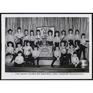 The Bunker Hillbillies pose with their instruments on a stage