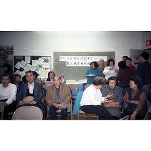 You King Yee and other members of the Chinese Progressive Association attend a holiday party at the organization's office