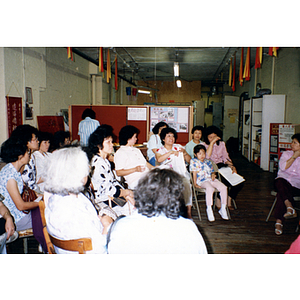 Woman speaks at a Chinese Progressive Association Workers' Center meeting