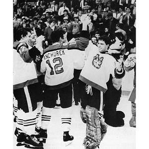 Men's ice hockey goalie Tim Marshall high fiving Captain Ken Manchurek