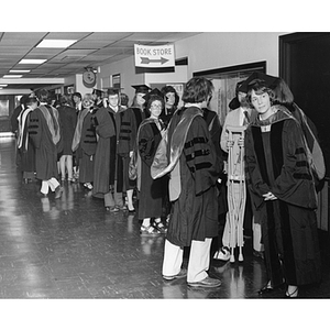 Robed law school graduates line up in the hallway for commencement