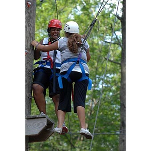 Ana Hidalgo and Nadia Alvarez laugh on the Torch Scholars Project Adventure Ropes Course