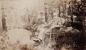 Francis Parkman seated in wicker chair, facing left