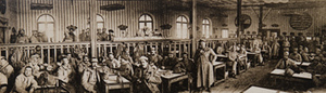 Panoramic view of soldiers inside a canteen, one soldier standing at center