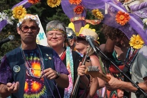 Purple Feather chocolate shop float in the parade, throwing beads to the crowd : Provincetown Carnival parade
