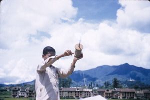 Boy prepares to fly a kite in Kathmandu