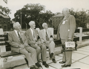 Four unidentified alumni from the class of 1894 talking on the patio of Worcester Dining Commons