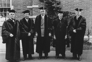 Hugh P. Baker with unidentified men in academic gowns during commencement weekend